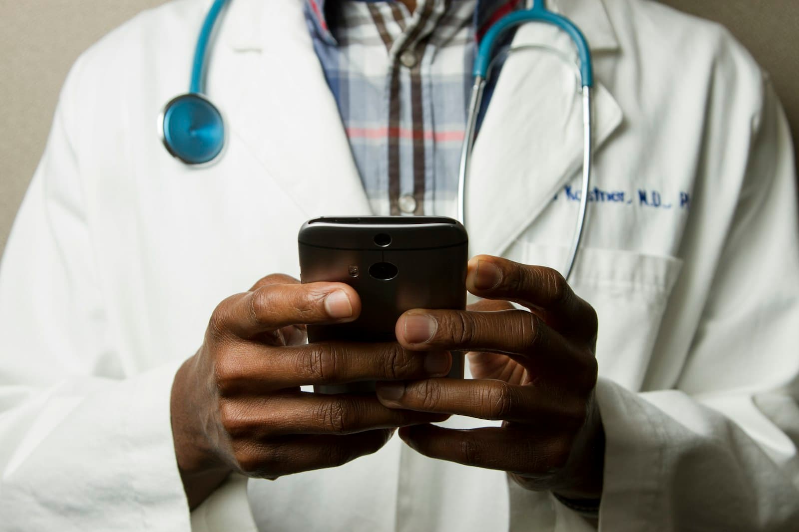 A clinician texting a patient from the pharmacy