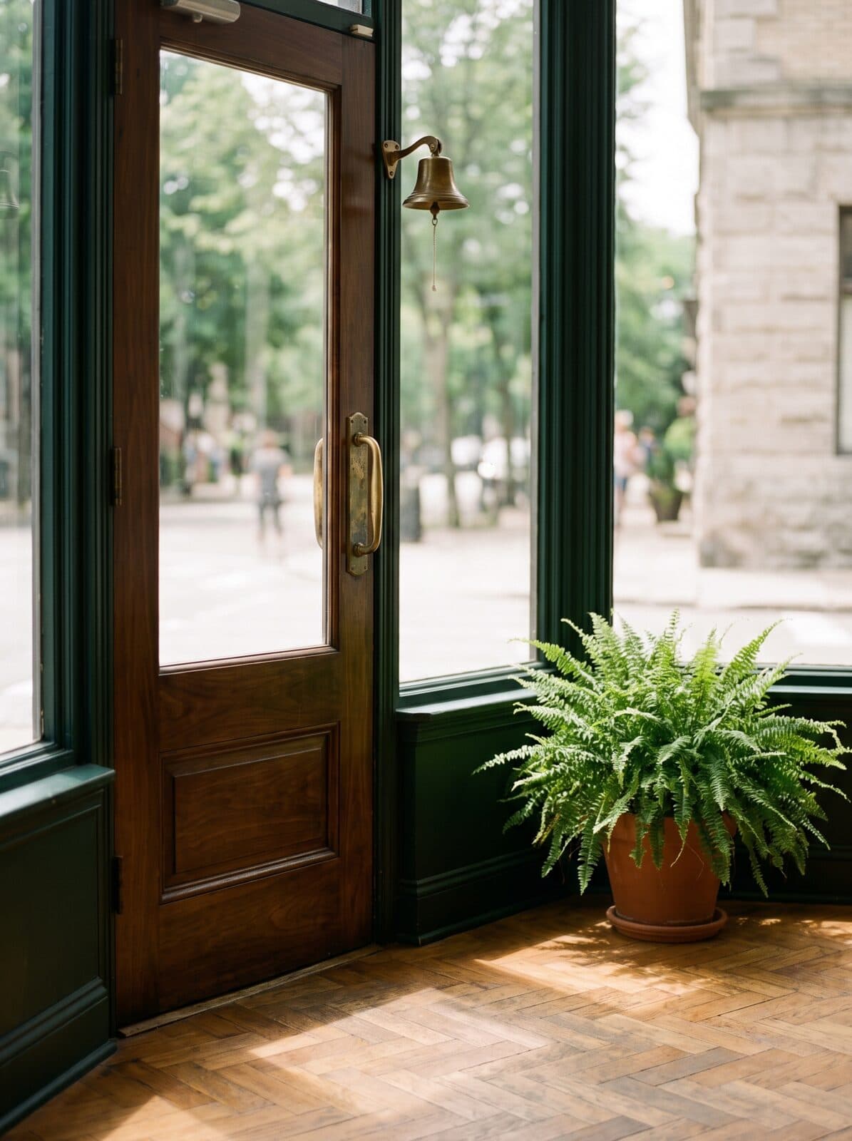 The pharmacy's front door with a small brass bell above it